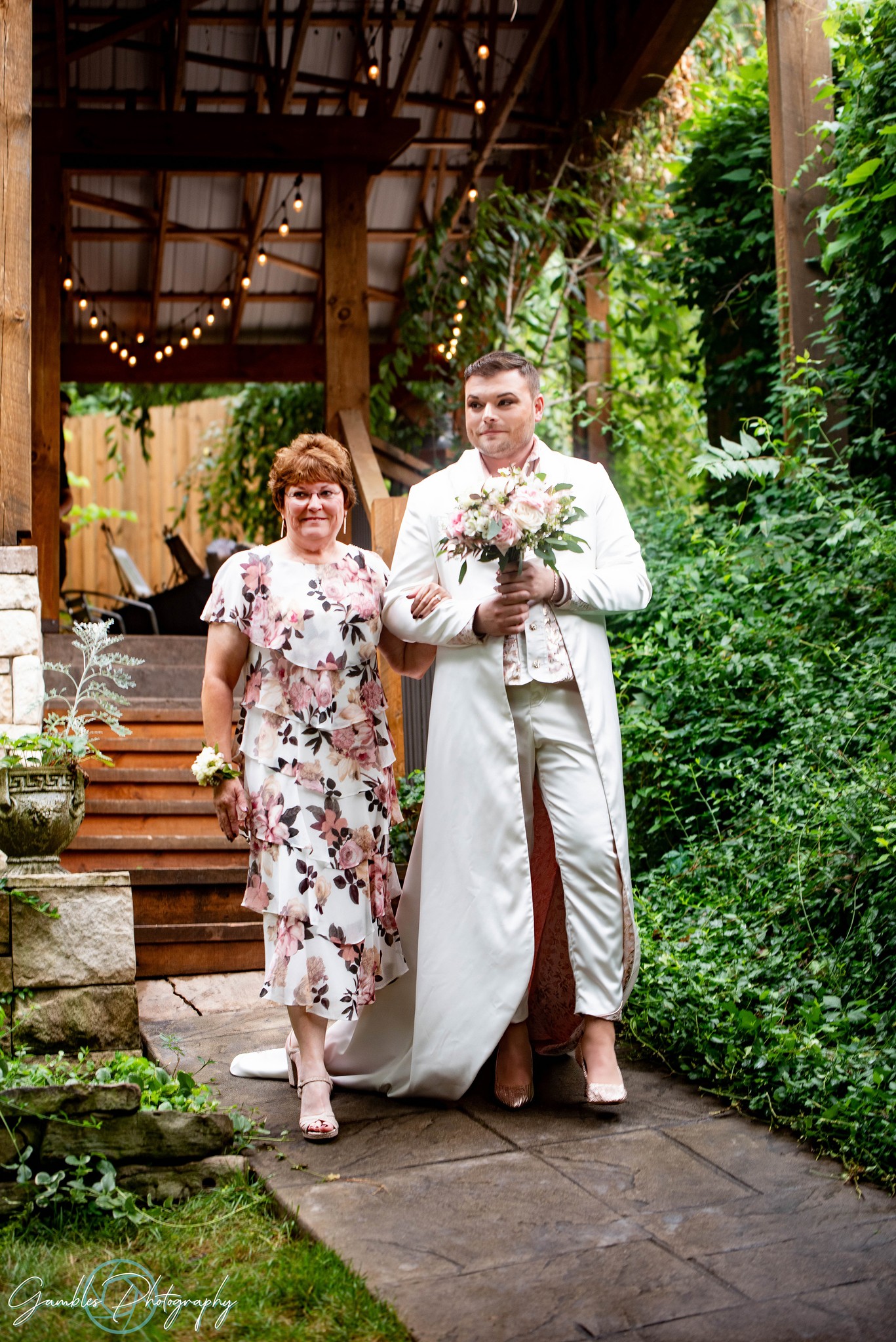 A mom walks her child down the aisle during a wedding at Affinity Riverside Estate, photographed by Gambles Photography.