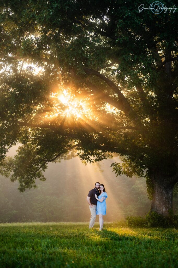 a couple stands during sunrise in Springfield, MO, photographed by Gambles Photography